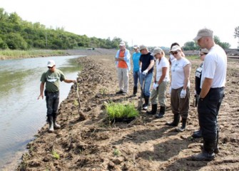 Volunteers preparing to plant native species. The plants will help re-establish wetlands and improve habitat and the ecosystem, creating a productive, healthy Onondaga Lake watershed.