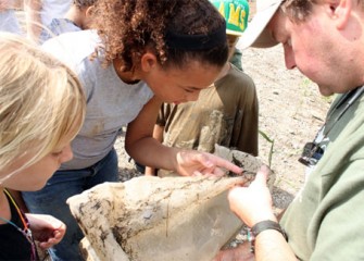 Steve Mooney, managing scientist and habitat specialist from O'Brien & Gere, describes the macroinvertebretes collected from Nine Mile Creek to Camp Green Team members. Samples help habitat experts monitor the success of restoration activities.