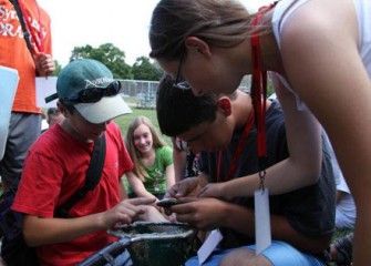 Students at Honeywell Summer Science Week Examine the Various Types of Fish they Caught in Nine Mile Creek at Munro Park.