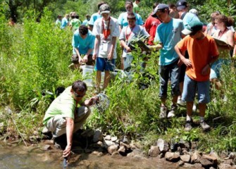Camp Counselor Michael Amadori Demonstrates How to Capture Eater Quality Measurements on Onondaga Creek to Honeywell Summer Science Week Students.
