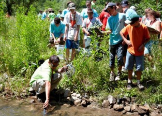 Camp Counselor Michael Amadori Demonstrates How to Capture Eater Quality Measurements on Onondaga Creek to Honeywell Summer Science Week Students.