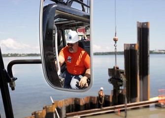 A Technician Controls the Vibratory Hammer from an Excavator