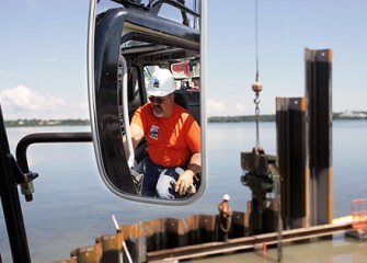 A Technician Controls the Vibratory Hammer from an Excavator