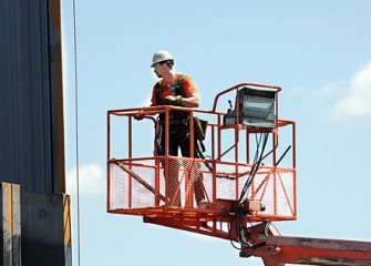 Worker Inspects Steel Panel