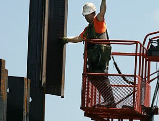 Worker Signals to Vibratory Hammer Technician