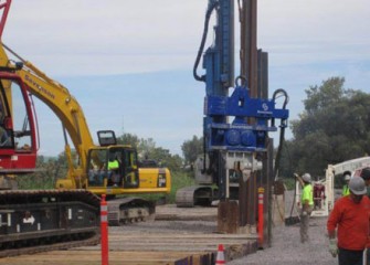 Barrier wall Phase III panels are driven into the ground.