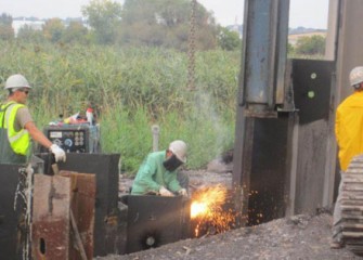 A worker uses a torch on the steel.