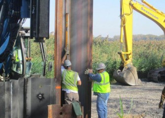 Workers check the alignment of the panels.