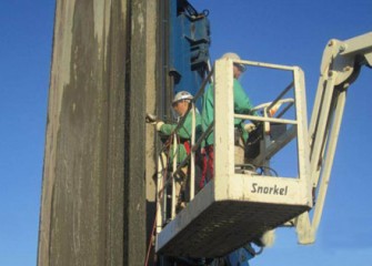 Workers check the steel.