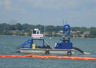 A capping barge on Onondaga Lake. The lake bottom cap will cover about 450 acres of the lake. The cap will provide a new habitat layer, prevent erosion, and isolate any remaining contaminants.