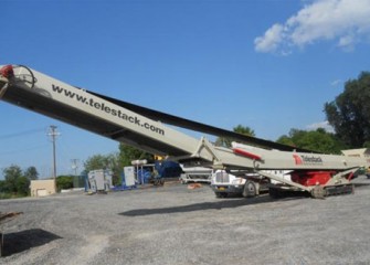 A weigh belt (conveyor belt with scale) is used to measure capping materials for the lake bottom.