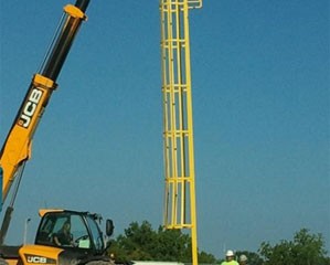 An enclosed ladder to attach to a carbon mixing tank.