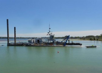 The cutter head on the largest dredge, Marlin, is raised to begin a maintenance check.