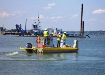 Crew on a small support boat heads out to assist operations.