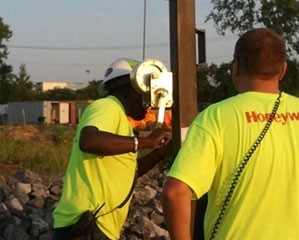 Workers set up lighting equipment for night operations.