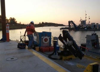 Equipment is loaded onto a support boat at sundown.