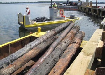 Workers monitor safety procedures throughout the process