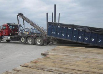 Containers are covered and transported to the debris management area at the consolidation area