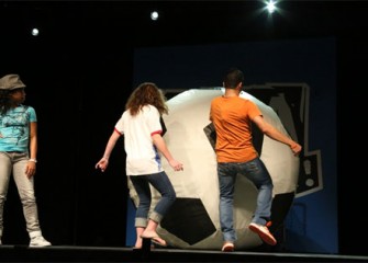 Eighth-grade student from West Genesee Middle School, and FMA Live! Performer Eric Olsen kick a giant soccer ball to demonstrate Newton's Second Law of Motion.