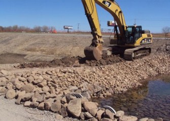 A temporary berm is built to redirect the flow of Geddes Brook