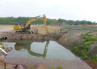 Process begins to remove a berm and allow water into the new Geddes Brook channel