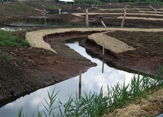 Water now flowing through the new meandering channel