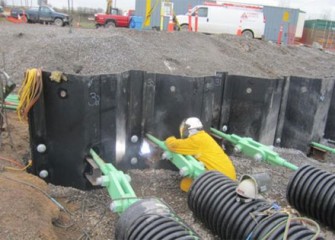 Worker connects tension rods to steel panels.