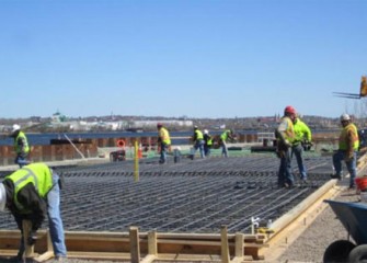 Skilled laborers build a frame for concrete.