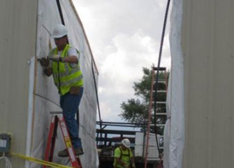 Workers prepare to connect the units