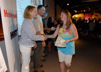 Onondaga County Executive Joanie Mahoney and Honeywell Syracuse Program Director John McAuliffe Congratulate a Student upon Completion of the Honeywell Summer Science Week at the MOST