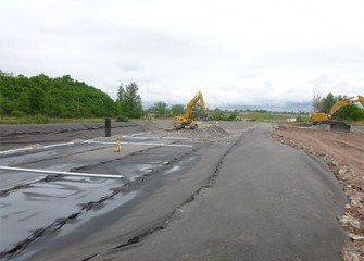 An area is constructed nearby Nine Mile Creek to allow excavated material to dry; a liner is placed beneath the entire area.