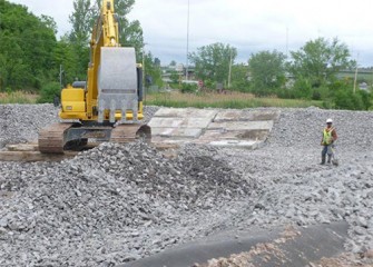 Gravel is placed over the liner to allow water to drain to collection systems.