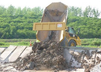 Material is taken to the lined area for drying.