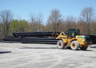 Sections of double-walled pipe assembled by Vari-Tech LLC in Liverpool, NY are stacked for delivery.