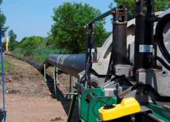 Early pipeline sections begin to form the system that will transport dredged material to the processing area.