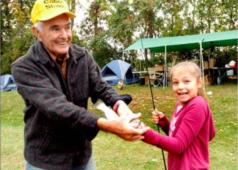 Paige Bird Catches a Trout at Carpenter's Brook with Help from Honeywell Sportsmen's Days Volunteer, Paul Schlenker