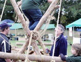 A Young Sportsman Tries out the Boy Scouts' Ropes Course