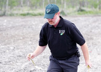 Timothy Volk Plants a Shrub Willow by Hand