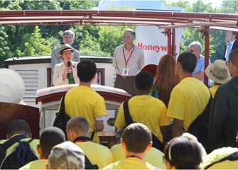 City of Syracuse Mayor Stephanie Miner talks about the importance of studying science, technology, engineering, and math before a Honeywell Summer Science Week at the MOST boat tour of Onondaga Lake. Honeywell Program Director John McAuliffe (right) and Museum of Science and Technology Exhibits Project Manager Peter Plumley (left) listen.