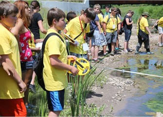 Summer Science Week students conduct stream profiles at Onondaga Creek, measuring the width of the stream and the depth of the water