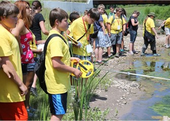 Summer Science Week students conduct stream profiles at Onondaga Creek, measuring the width of the stream and the depth of the water