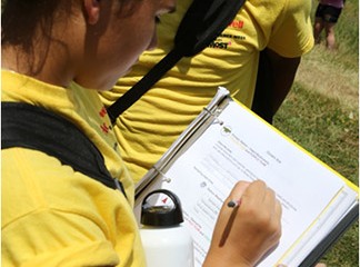 A student records findings and observations in her Honeywell Summer Science Week at the MOST notebook.