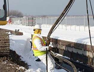 Worker Moves Cables