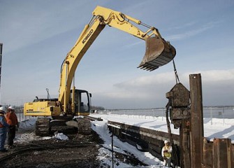 Hammer Drives Steel Panel into Place