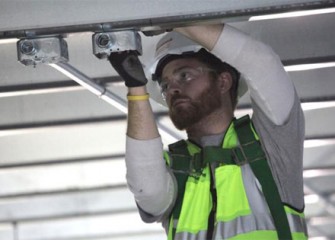 Worker installing lighting conduit