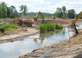 Clean soil is placed along creek banks.