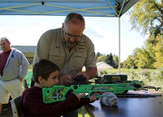 Logan Wood, of Liverpool, N.Y., learns how to use a crossbow.