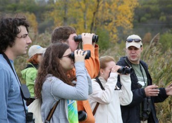Frank Moses, director of the Montezuma Audubon Center, leads volunteers from the State University of New York College of Environmental Science and Forestry (SUNY-ESF) on a birding walk to track native birds.