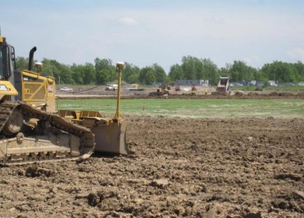 Construction Equipment Uses GPS to Place the Impermeable Clay Base Layer