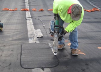 Technicians Collect Liner Samples for Testing. A Worker Seals a Patch Over a Sampled Area